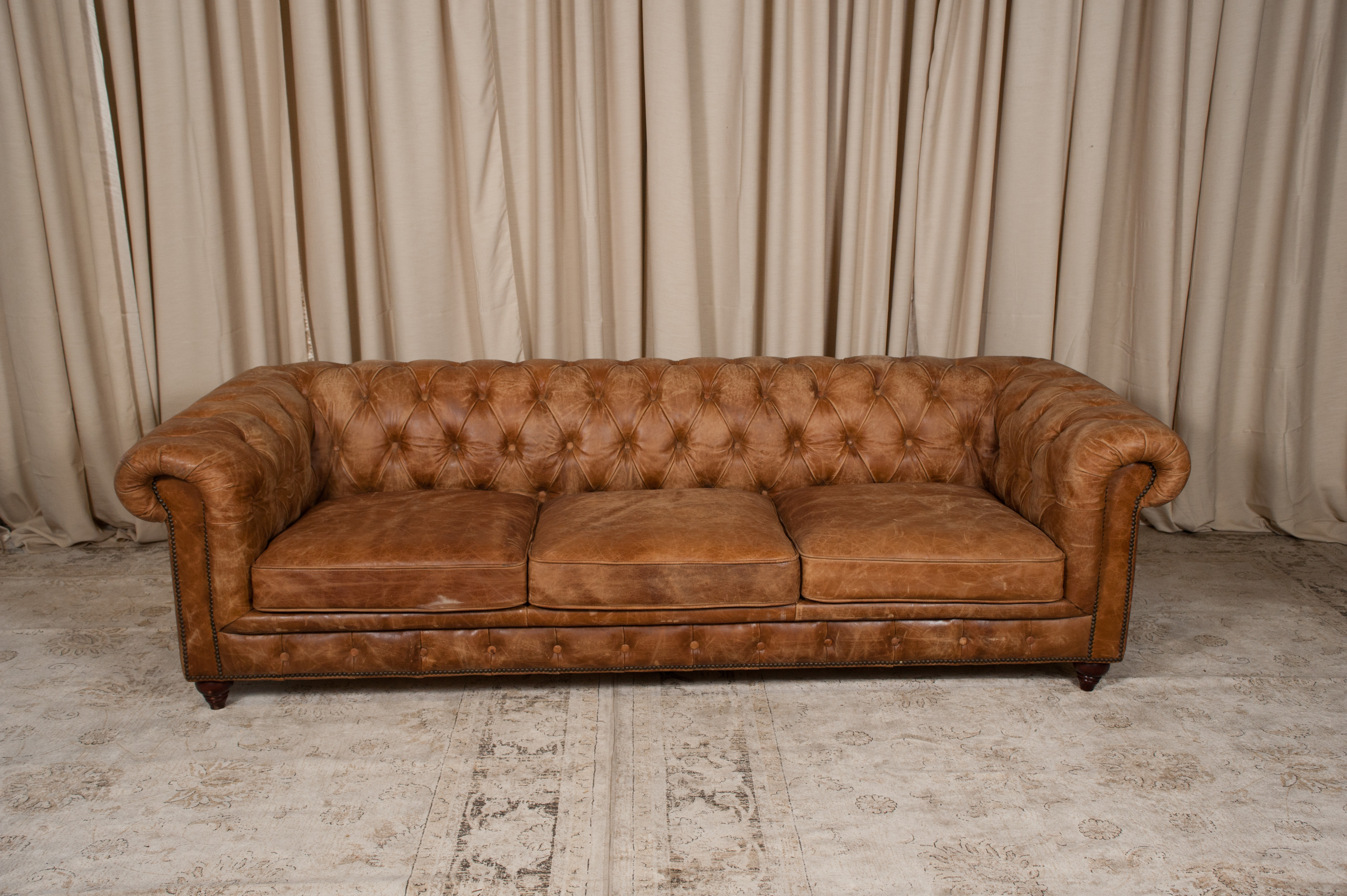 brown leather chesterfield sofa in living room